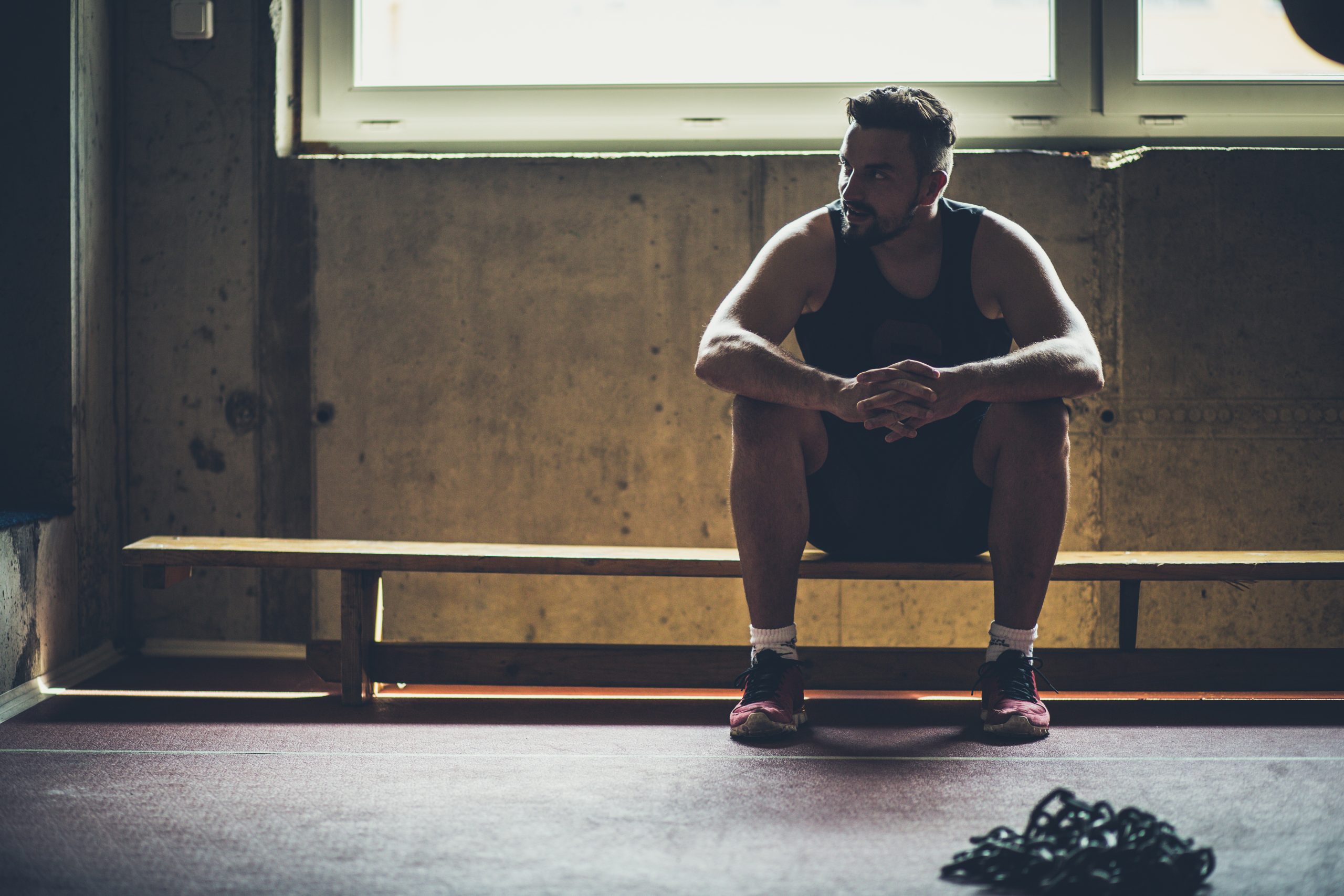 Man doing workout in the gym and resting Man doing workout in the gym and resting